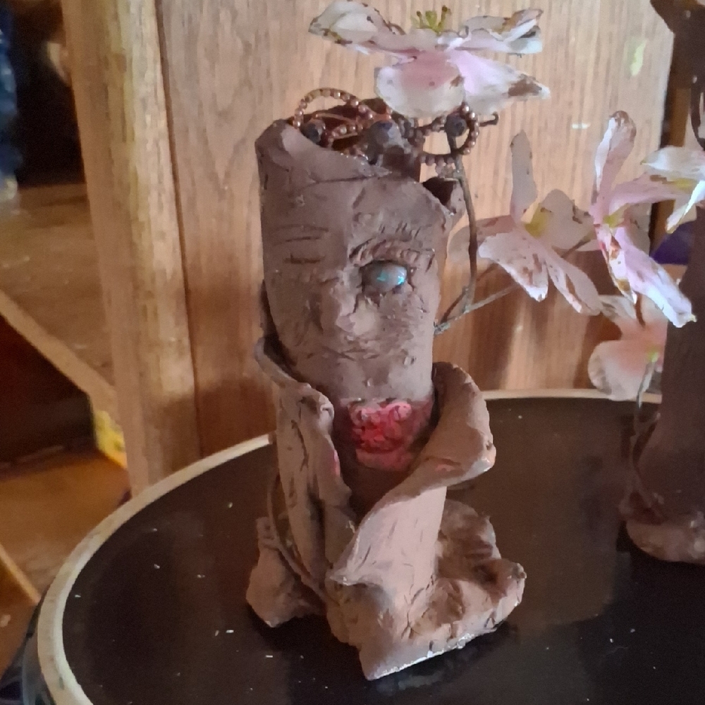 Handcrafted Brown Ceramic Art Piece with Floral Accent